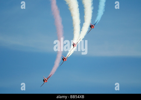 Red Arrows Hawk aircraft swoop by during their display at Dawlish Carnival Airshow Stock Photo