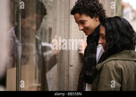 teenager couple in front of shopwindow Stock Photo