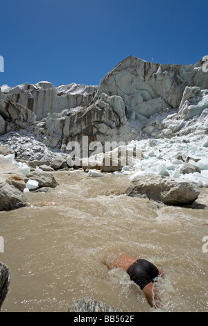 Pilgrim bathing in the source of Ganges river. Gaumukh Glacier (3892m). Gangotri National Park. Uttarakhand. India Stock Photo