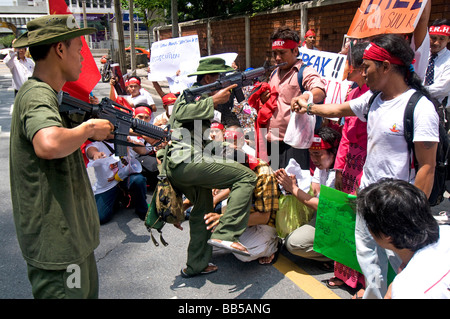 Pro democracy protestors clash with other protestors dressed as Burmese soldiers in front of the Burmese Embassy in Bangkok Stock Photo