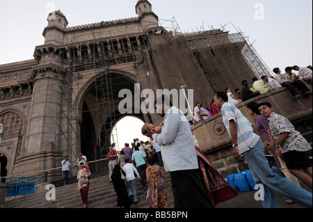 People gather at the foot of the Gateway of India, a popular tourist attraction situated in the south of the city of Mumbai. Stock Photo