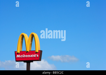 McDonald's Sign and Logo against blue sky Stock Photo