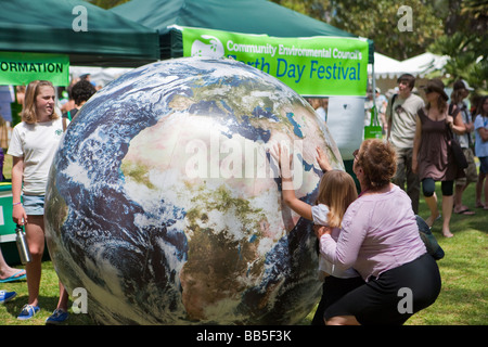 child playing with inflated world globe Earth Day Celebration Santa Barbara California United States of America Stock Photo