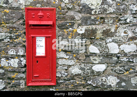 A red post box on a wall in Cornwall, England, UK Stock Photo