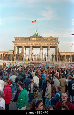 Crowds in front of Berlin Wall and Brandenburg Gate in 1989, Berlin, Germany Stock Photo