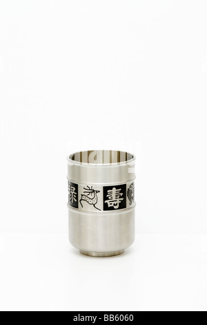 Satin finished tin metal tumbler decorated with Chinese characters and pictures. Isolated (cutout, cut-out) on white. May, 2009 Stock Photo