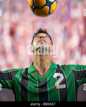 Soccer player heading the ball Stock Photo