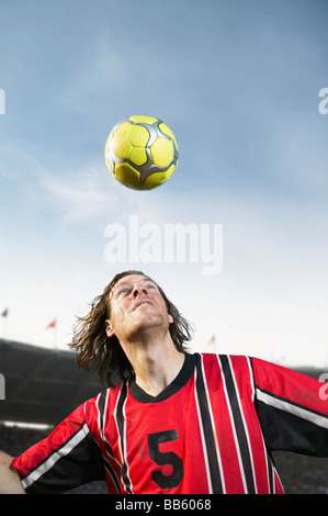 Soccer player headering the ball Stock Photo