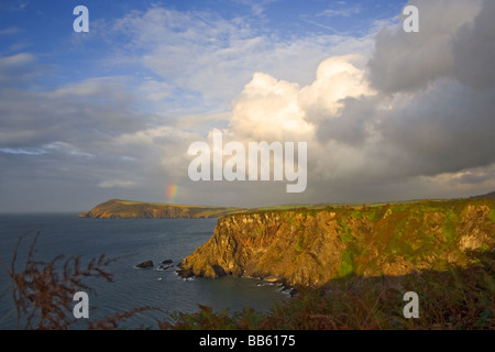 View across Fishguard Bay after heavy rain. Distant rainbow. Pembrokeshire, Wales. UK. Cumulus and nimbostratus clouds. Stock Photo