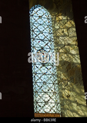 A stained glass window inside Brinkburn Priory and Hall, near Rothbury in Northumberland England UK Stock Photo