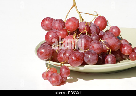 Cluster of red grapes on white bacground Stock Photo