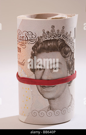 new and unused roll of UK Sterling mint ten pound bank notes rolled up. Stock Photo