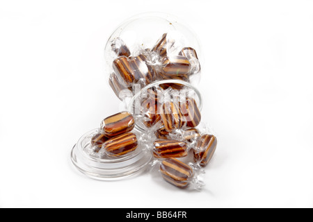 Sweet humbugs or candy in a jar on white Stock Photo