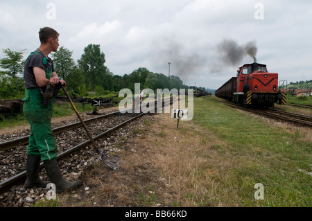 Railway maintenance workers repairing railway line tracks in the industrial town of Tuzla in Bosnia and Herzegovina Stock Photo