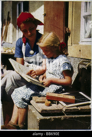 Nazism / National Socialism, organisations, Reichsarbeitsdienst (Reich Labour Service), young woman helping girl with homework, 1930s, 30s, , Stock Photo