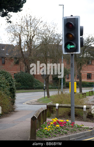 Green traffic light with an arrow showing a traffic filter in a town in England Stock Photo