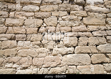 Close up of ancient stone wall with many cracked blocks Stock Photo