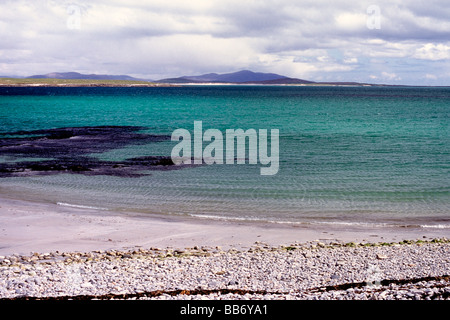 A clear sea laps the shore of a deserted island in Scotland Stock Photo