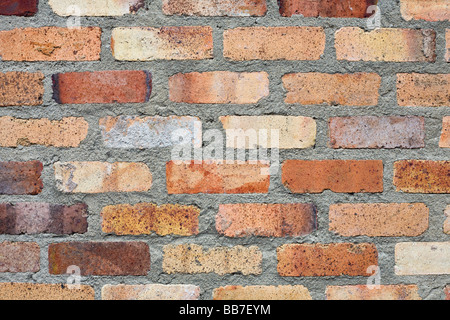 Bricks and Mortar. Orange fired bricks set in thick grey mortar Stock Photo