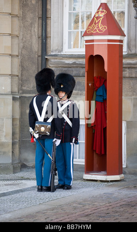 Changing the Guard. Two Danish palace guards size each other up during the ceremonial changing of the guard. Stock Photo