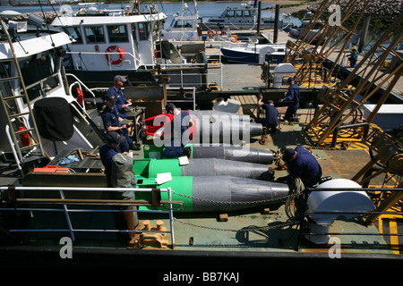 Members of the US Coast Guard prepare to move channel markers to Long Island Sound after they have been refurbished and painted Stock Photo