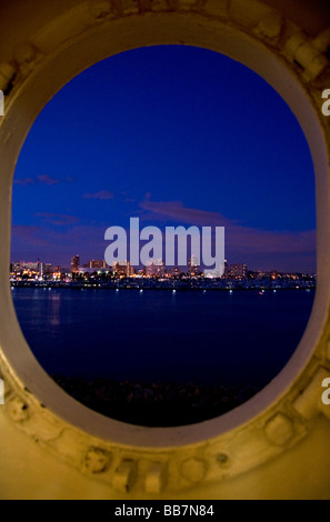 View of the city of Long Beach at night from a porthole on the Queen Mary museum and hotel ship at Long Beach Califorina USA Stock Photo