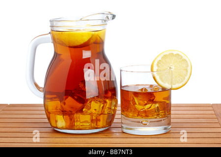 Ice tea pitcher and glasss with lemon and icecubes on wooden background Shallow depth of field Stock Photo