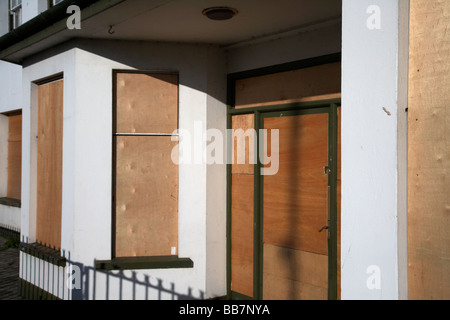 boarded up house front due to non sale and economic slowdown Stock Photo