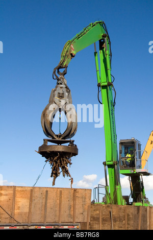 Electromagnetic crane lifting scrap steel for recycling at the Pacific Steel and Recycling center in Elmore County Idaho Stock Photo