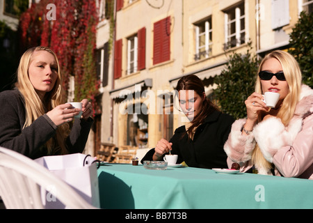 three women in a street cafe Stock Photo