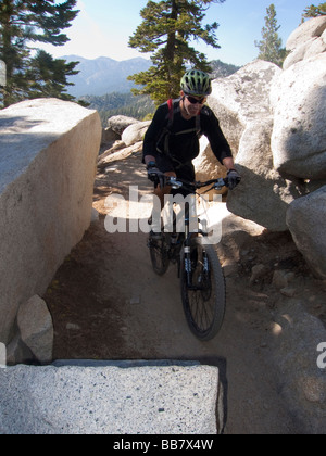 A mountain biker enjoys a view of Lake Tahoe from the Great Flume Trail near Spooner Summit . Stock Photo