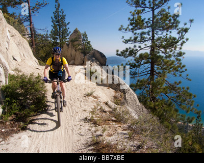 A mountain biker enjoys a view of Lake Tahoe from the Great Flume Trail near Spooner Summit . Stock Photo