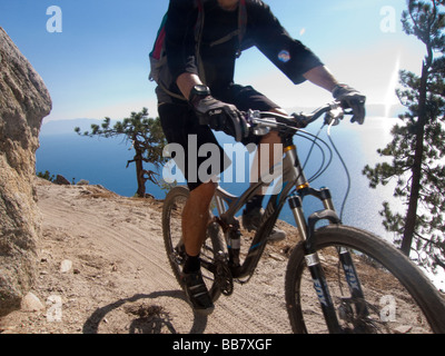 A mountain biker enjoys a view of Lake Tahoe from the Great Flume Trail near Spooner Summit . Stock Photo