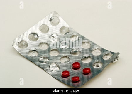 Four small red sinus pills in a foil and plastic bubble pack Stock Photo