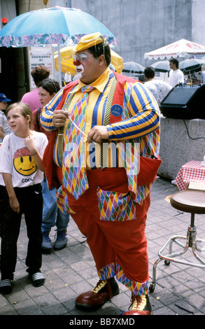 Large clown holding thin balloon Stock Photo