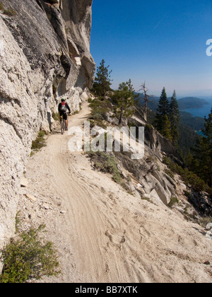 A mountain biker enjoys a view of Lake Tahoe from the Great Flume Trail near Spooner Summit . Stock Photo