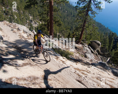 A mountain biker enjoys a view of Lake Tahoe from the Great Flume Trail near Spooner Summit . Stock Photo