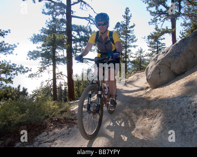 A mountain biker enjoys a view of Lake Tahoe from the Great Flume Trail near Spooner Summit . Stock Photo