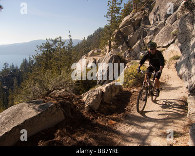 A mountain biker enjoys a view of Lake Tahoe from the Great Flume Trail near Spooner Summit . Stock Photo