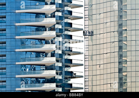 Window cleaner in front of highrise glass front, Dubai, United Arab Emirates Stock Photo