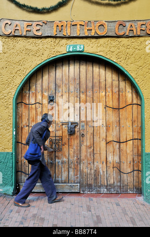 Elderly man in front of a colonial wooden gate, La Candelaria district, Bogotá, Colombia, South America Stock Photo