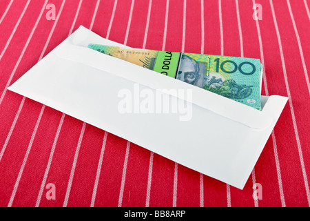 stack of one hundered dollar bills in a plain envelope Stock Photo