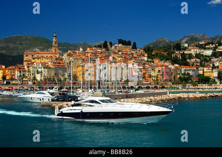 Luxury yacht leaving the old port of Menton, Côte d'Azur, France Stock Photo