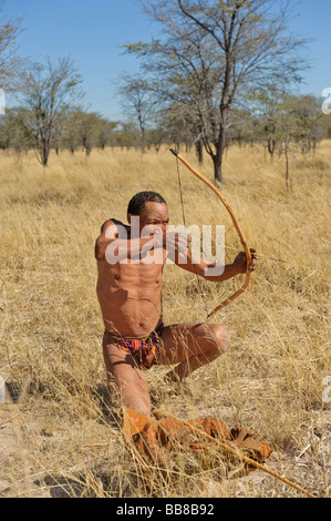 San man demonstrating the use of a bow and arrow, Zelda Guestfarm, Namibia, Africa Stock Photo