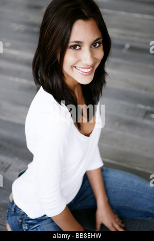 Portrait of young smiling kneeling beautiful woman Stock Photo