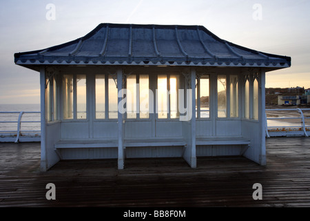 Rain Shelter, 'Seaside shelter' on Cromer Pier, Norfolk, UK sunrise over the sea. Stock Photo
