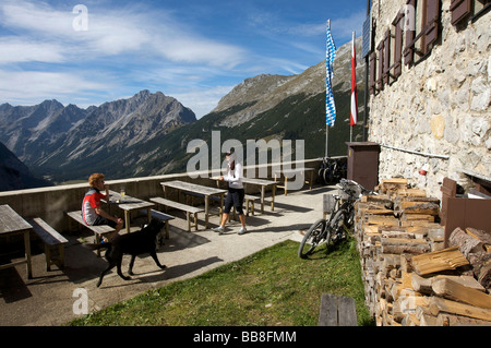 Mountainbike riders, male and female, taking a break at Karwendelhaus, alpine club house, Scharnitz, Tyrol, Austria, Europe Stock Photo