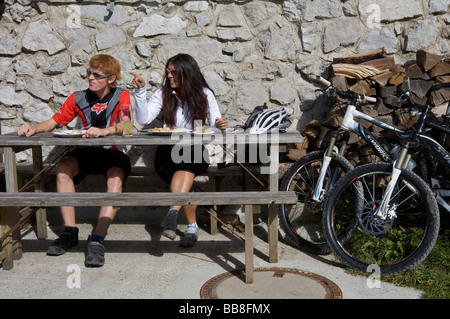 Mountainbike riders, male and female, taking a break at Karwendelhaus, alpine club house, Scharnitz, Tyrol, Austria, Europe Stock Photo