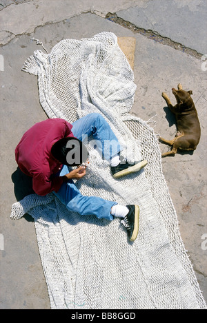 Majorcan fisherman repairing a fishing net, view from above, Puerto de Sòller, Majorca, Balearic Islands, Spain, Europe Stock Photo