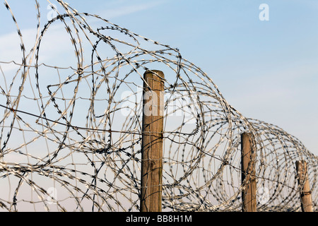 Fence, secured with NATO wire, barbed wire Stock Photo